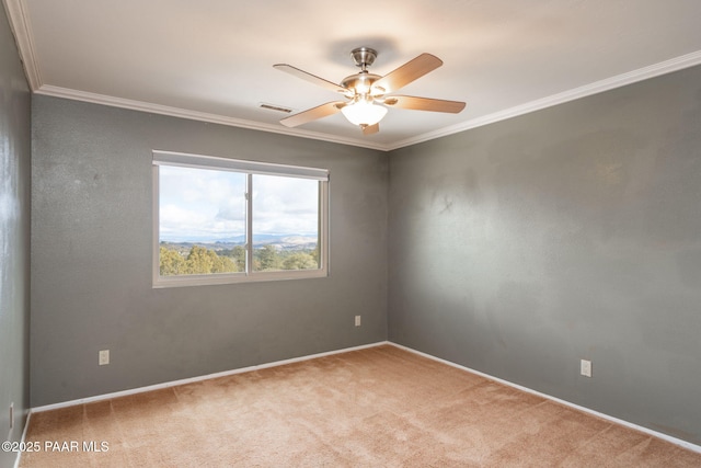 unfurnished room featuring crown molding, carpet floors, and ceiling fan