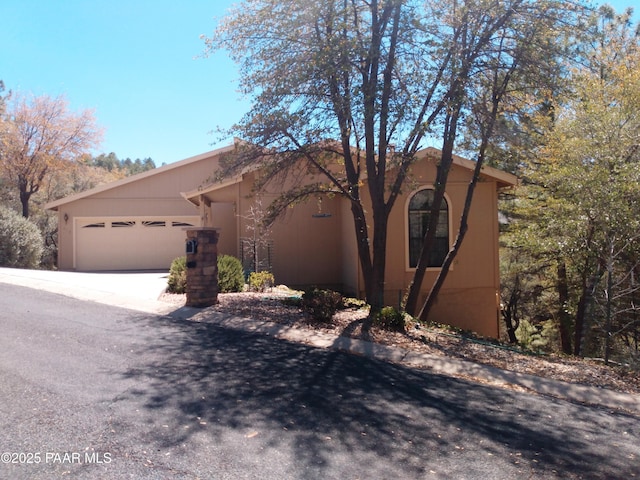 918 Marcus Dr, Prescott, AZ 86303 - view of front of house featuring an attached garage, driveway, and stucco siding