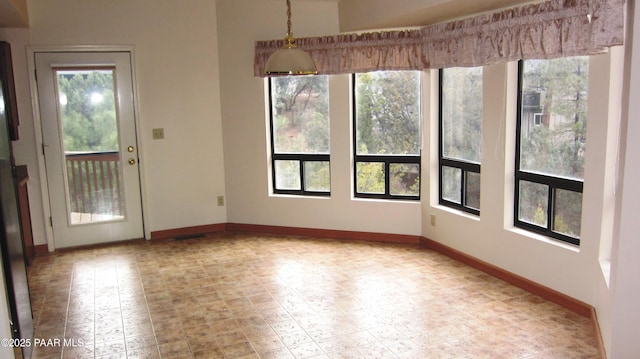 unfurnished dining area with baseboards