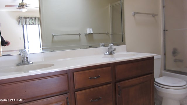 918 Marcus Dr, Prescott, AZ 86303 - bathroom with double vanity, toilet, bath / shower combo with glass door, and ceiling fan