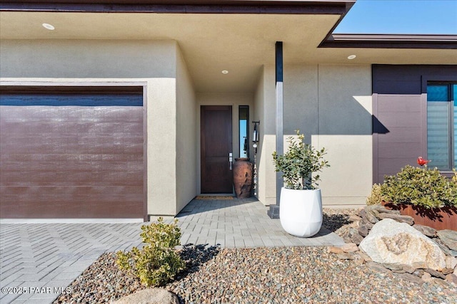 view of exterior entry featuring a garage