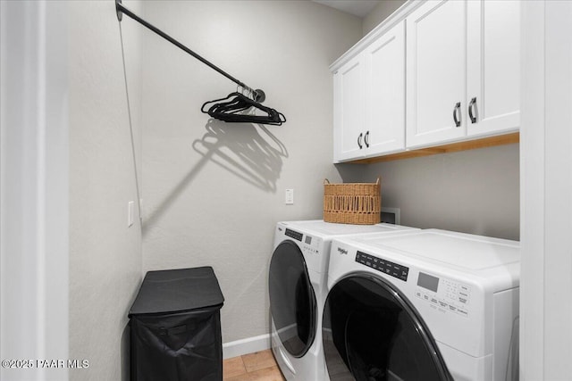 washroom with cabinets, independent washer and dryer, and light tile patterned flooring