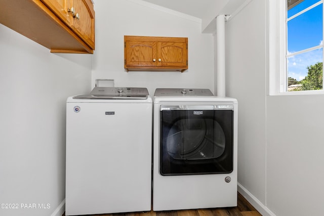 washroom with cabinets, dark wood-type flooring, and washing machine and clothes dryer