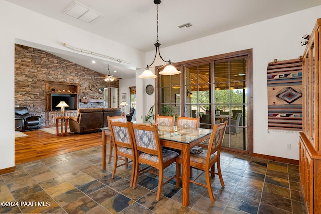 dining area featuring ceiling fan, dark hardwood / wood-style floors, and vaulted ceiling