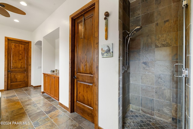 bathroom featuring ceiling fan and walk in shower