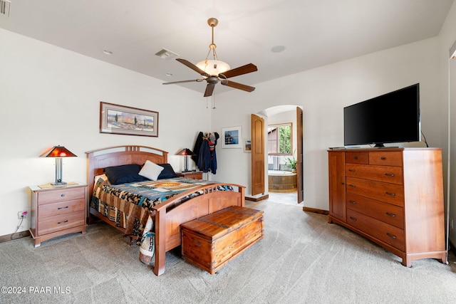 bedroom with carpet flooring, ceiling fan, and ensuite bathroom