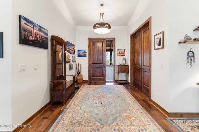 foyer featuring lofted ceiling and dark hardwood / wood-style floors