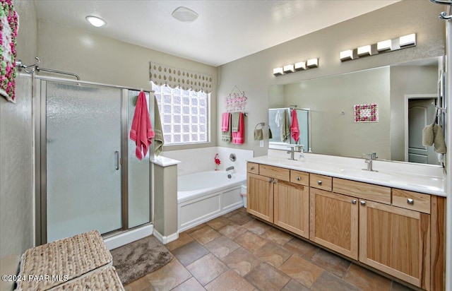 bathroom featuring plus walk in shower and vanity