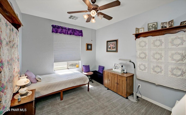 bedroom with ceiling fan and light carpet