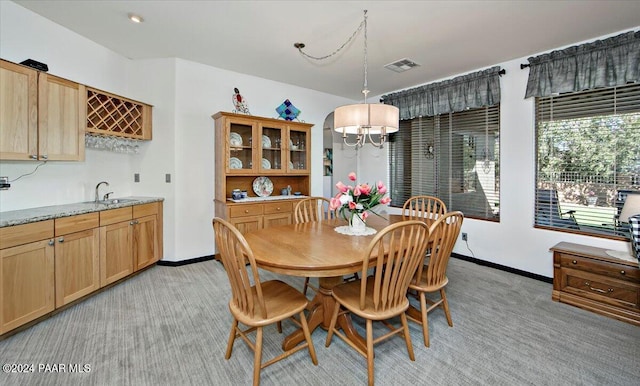 carpeted dining area featuring sink