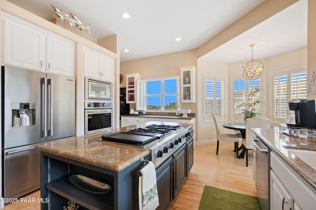 1671 W Catim Way, Prescott, AZ 86305 - kitchen featuring appliances with stainless steel finishes, open shelves, white cabinets, light stone countertops, and a chandelier