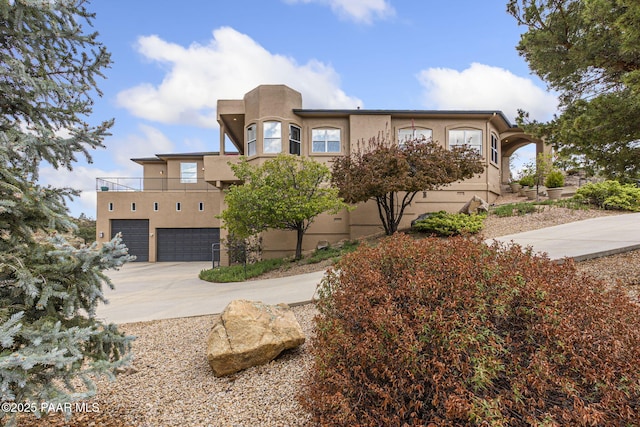 1671 W Catim Way, Prescott, AZ 86305 - view of front of home with stucco siding, an attached garage, driveway, and a balcony