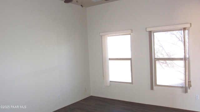 empty room featuring ceiling fan and dark hardwood / wood-style floors