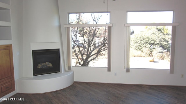 unfurnished living room featuring dark wood-type flooring