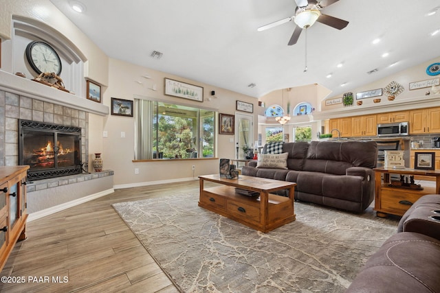 5570 N Pierce Ln, Prescott Valley, AZ 86314 - living area with a ceiling fan, a tiled fireplace, light wood-type flooring, baseboards, and recessed lighting