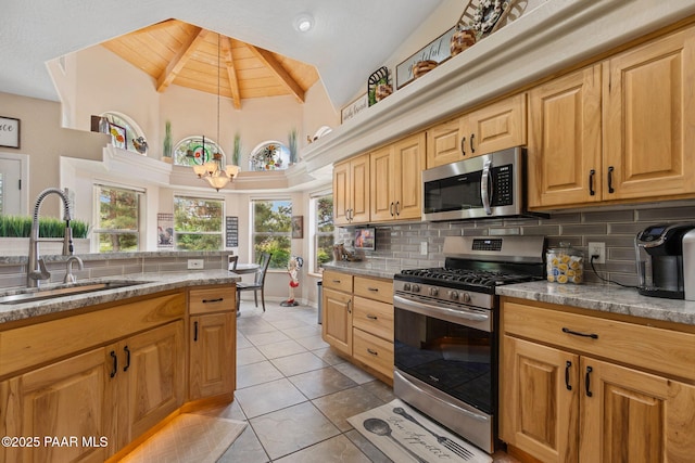 5570 N Pierce Ln, Prescott Valley, AZ 86314 - kitchen with appliances with stainless steel finishes, a sink, decorative backsplash, high vaulted ceiling, and light tile patterned floors