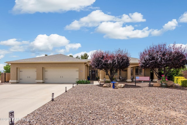 5570 N Pierce Ln, Prescott Valley, AZ 86314 - view of front facade featuring an attached garage, stucco siding, and concrete driveway