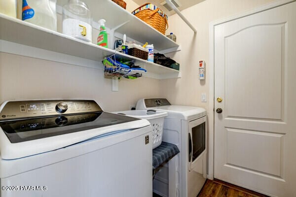 clothes washing area featuring laundry area, dark wood-style floors, and separate washer and dryer
