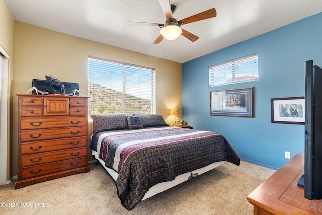 bedroom featuring a ceiling fan and light colored carpet