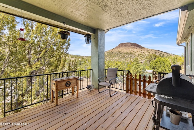 wooden terrace with a mountain view and area for grilling