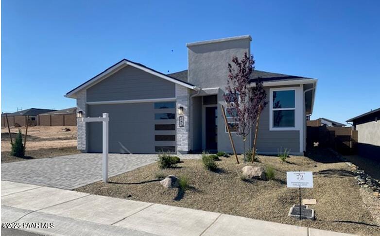 1220 Woodchute Rd Unit 72, Prescott, AZ 86305 - view of front of house with an attached garage, decorative driveway, and fence