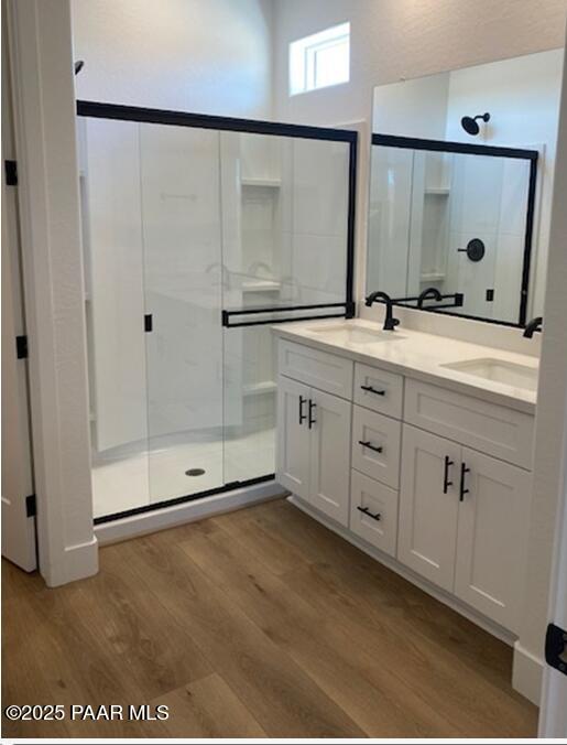 1220 Woodchute Rd Unit 72, Prescott, AZ 86305 - bathroom with a shower stall, wood finished floors, and double vanity