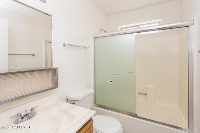 full bathroom featuring vanity, toilet, and enclosed tub / shower combo