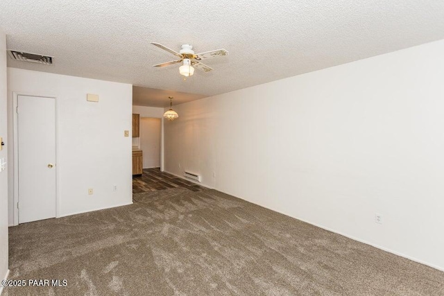 empty room featuring visible vents, a textured ceiling, a ceiling fan, and carpet floors