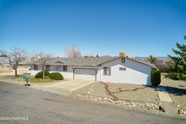 ranch-style house with an attached garage and driveway