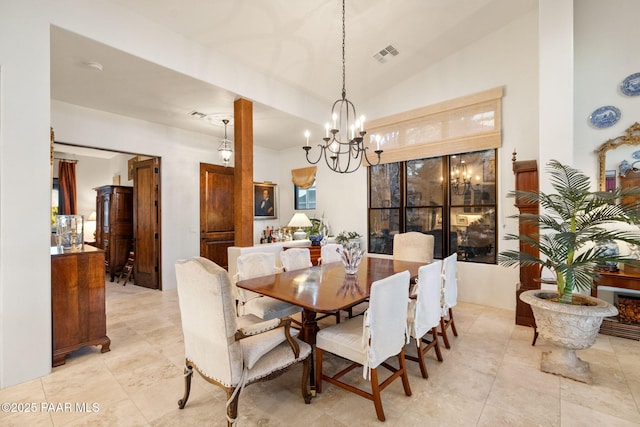 dining room with lofted ceiling, visible vents, and a notable chandelier