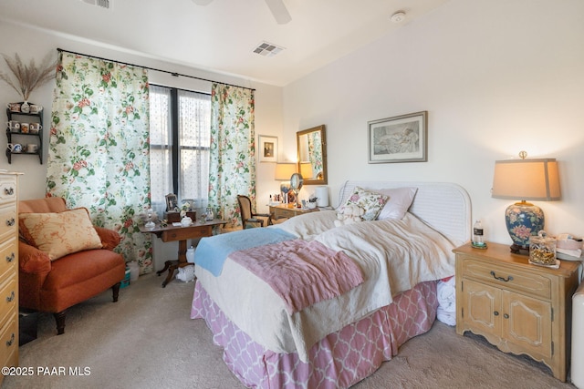 carpeted bedroom with ceiling fan and visible vents