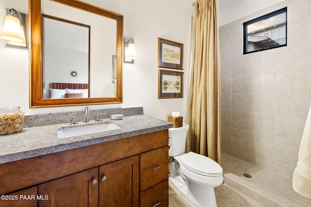 full bathroom with toilet, tile patterned floors, a tile shower, and vanity