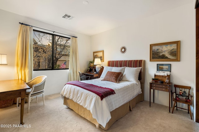 bedroom featuring visible vents and light colored carpet