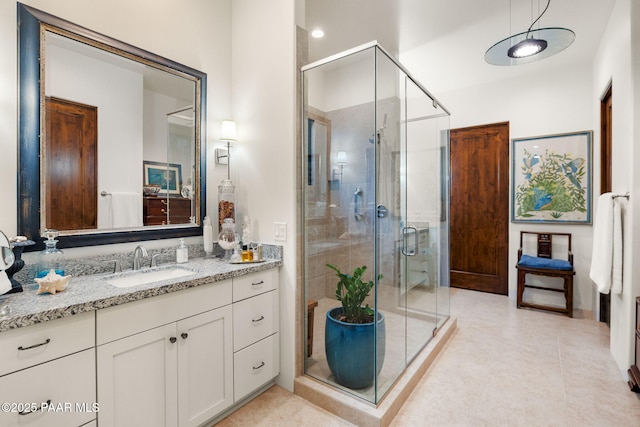 bathroom featuring a shower stall, vanity, and tile patterned floors