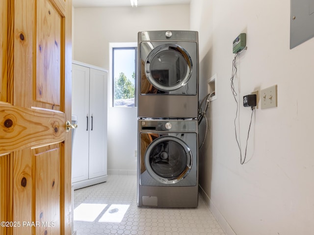22891 S Lakewood Dr, Yarnell, AZ 85362 - washroom featuring laundry area, baseboards, stacked washer and clothes dryer, and light floors
