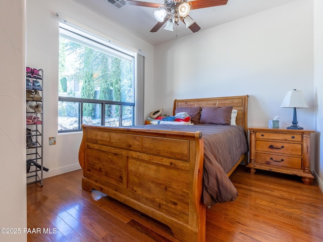 22891 S Lakewood Dr, Yarnell, AZ 85362 - bedroom featuring baseboards, multiple windows, hardwood / wood-style flooring, and visible vents