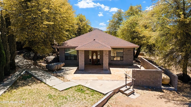 22891 S Lakewood Dr, Yarnell, AZ 85362 - back of property featuring a shingled roof and a patio area