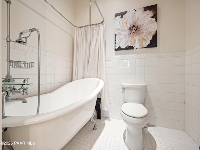 22891 S Lakewood Dr, Yarnell, AZ 85362 - full bath with a freestanding tub, tile walls, tile patterned floors, a wainscoted wall, and toilet