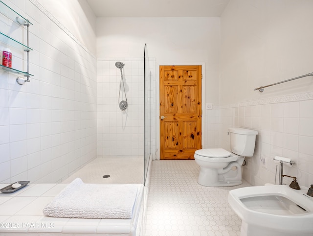 22891 S Lakewood Dr, Yarnell, AZ 85362 - bathroom with tile walls, a shower stall, toilet, and a bidet