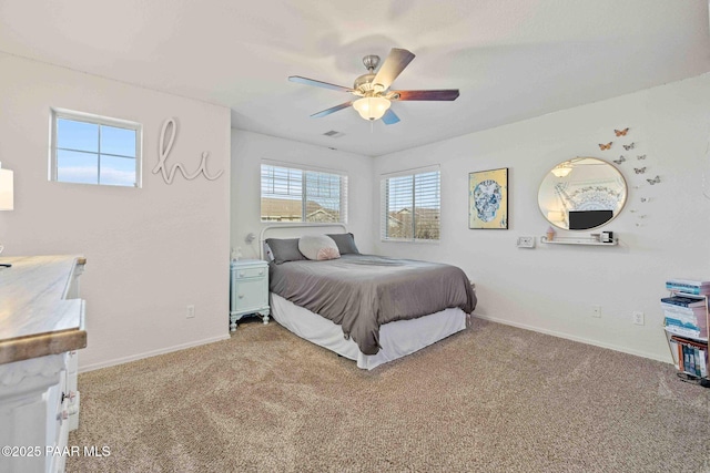 bedroom featuring baseboards, ceiling fan, light carpet, and visible vents
