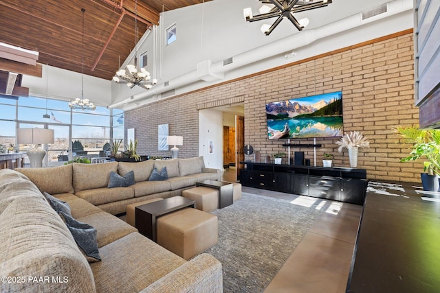 living room with an inviting chandelier, high vaulted ceiling, brick wall, visible vents, and wooden ceiling