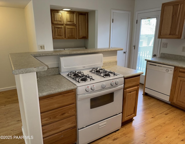 719 S Granite St Unit D 8, Prescott, AZ 86303 - kitchen with white appliances, brown cabinetry, and light wood finished floors