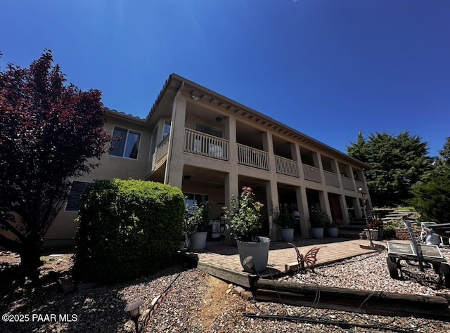 4433 N La Jolla Cir, Prescott Valley, AZ 86314 - back of house with a balcony, stucco siding, and a patio