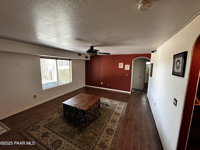 4433 N La Jolla Cir, Prescott Valley, AZ 86314 - living room with arched walkways, a ceiling fan, a textured ceiling, and dark wood finished floors