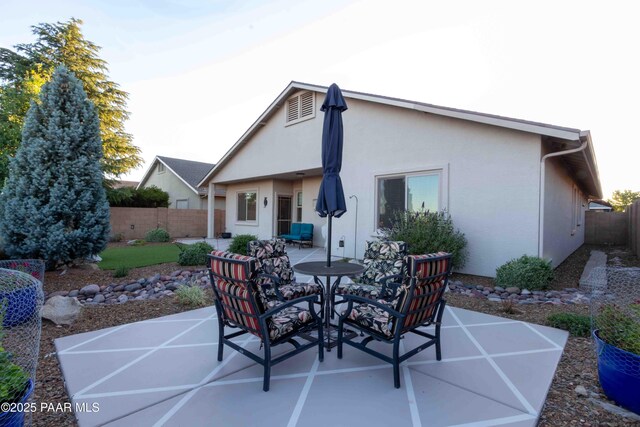 12933 Ponce St, Dewey-Humboldt, AZ 86327 - rear view of house with a patio, a fenced backyard, stucco siding, and outdoor dining area
