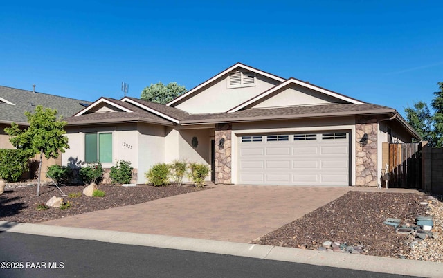 12933 Ponce St, Dewey-Humboldt, AZ 86327 - ranch-style house with stone siding, an attached garage, stucco siding, and decorative driveway
