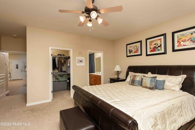 12933 Ponce St, Dewey-Humboldt, AZ 86327 - bedroom featuring light colored carpet, a spacious closet, a closet, ensuite bath, and ceiling fan