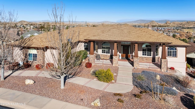 view of front of property with a mountain view and a porch