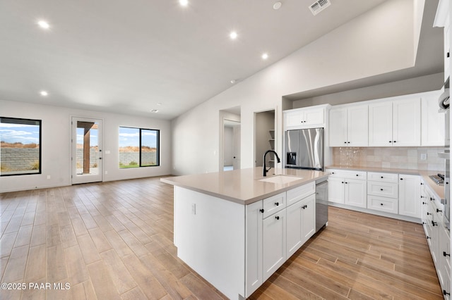 5734 E Hahn St, Prescott Valley, AZ 86314 - kitchen with visible vents, a sink, open floor plan, light wood-style floors, and stainless steel appliances