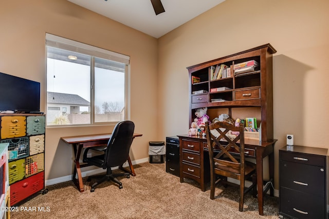 office area featuring light carpet, a ceiling fan, and baseboards